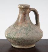 A Gallo-Roman terracotta flagon, c. 1st century A.D., of squat oviform, remnants of green glaze,