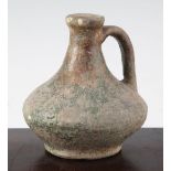 A Gallo-Roman terracotta flagon, c. 1st century A.D., of squat oviform, remnants of green glaze,