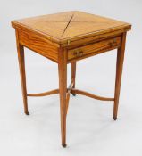 A 19th century satinwood and rosewood crossbanded envelope card table, with green baize interior and