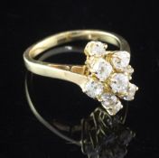 A French 18ct gold and diamond ring, of marquise design, set with nine graduated old cut diamonds,