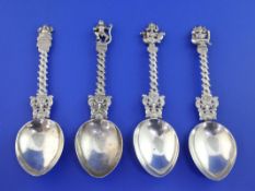 A set of four late 19th/early 20th century Indian silver spoons, with pierced spiral stems and Deity