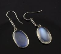 A pair of platinum and moonstone drop earrings, set with oval cut cabochon stone, 1.5in.