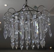 A Victorian cut glass lustre hung chandelier, with pear shape and prismatic drops, W.1ft 8in.