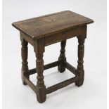 A 17th century oak joynt stool, with baluster turned legs united by stretchers, W.1ft 6.5in.