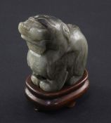 A Chinese pale grey and black jade carving of a lion-dog, Ming dynasty, in seated pose, 6cm., wood