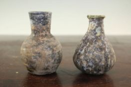 Two Syrian glass gourd flasks, c.6th century A.D., with mineral iridescence, 8.5cm