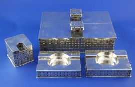 A stylish early 1970's silver smoker's companion set, of rectangular form, with "basket weave"