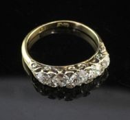 An early 20th century 18ct gold and graduated five stone diamond half hoop ring, set with old and