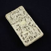 A Chinese export ivory card case, 19th century, typically carved in high relief with figures amid