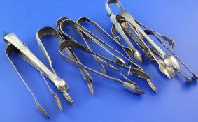 Thirteen pairs of Georgian and later silver sugar tongs, of various patterns, including 18th century