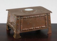 An Arts & Crafts copper table casket, the rectangular lid inset with raised oval stone, 5.5in.