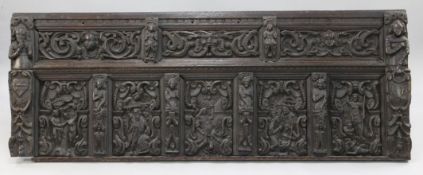 A 17th century Flemish carved oak coffer front, with various panels and figural carvings,