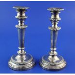 A pair of George III silver candlesticks, with turned tapering stems and engraved armorial, (a.