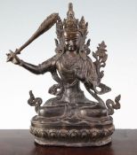A Sino-Tibetan bronze seated figure of Manjushri, holding a sword and seated on a lotus throne,