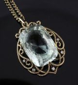 A 1970's gold, aquamarine and diamond pendant, with large fancy cut aquamarine in an openwork gold