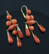 A pair of gold and coral bead drop earrings, each with three teardrop shaped drops, overall 2in.