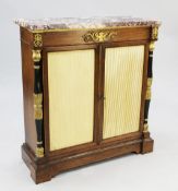 A Regency rosewood and ormolu mounted marble top side cabinet, fitted a pair of cupboard doors