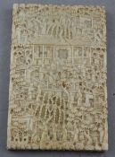 A Chinese export ivory card case, 19th century, carved in relief with figures amid pavilions and