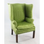 A George III style wingback armchair, upholstered in a green Moray fabric, on moulded square section