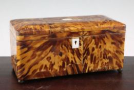 A Victorian blond tortoiseshell tea caddy, the hinged lid revealing a central space for mixing