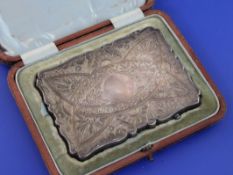 A cased late Victorian silver card case, of shaped rectangular form, with engraved geometric foliate