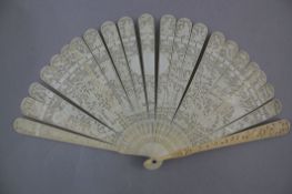 A Chinese export ivory brise fan, late 19th century, the guards carved in relief with a dragon and