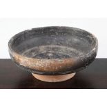 A Greek blackware rouletted bowl, Apulia c 4th century B.C., with impressed design to the