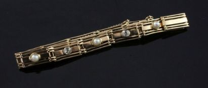 An early 20th century 15ct gold, split pearl and diamond gate link bracelet, set with four split