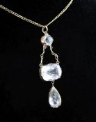 An Edwardian gold and pale aquamarine triple drop pendant, set with round, cushion and pear shaped