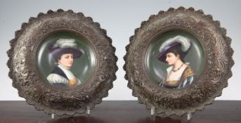 A pair of bronze framed Paris porcelain dishes, late 19th century, each painted to the centre with