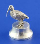 A George V silver paperweight modelled as a curlew on a plinth base, retailed by Asprey, with two