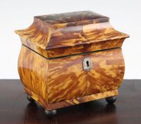 A 19th century bombe shape tortoiseshell tea caddy, the shaped rectangular lid revealing a two