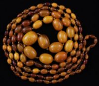 A long single strand graduated oval amber bead necklace, gross weight 120 grams, 70in.