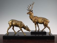 Jules Edmond Masson. A patinated bronze figure group of a stag and doe, on a rectangular marble