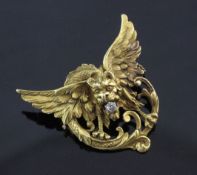 A pierced 18ct gold and diamond winged gargoyle brooch, set with a single old cut diamond, (no pin),