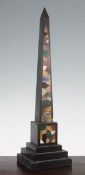 A 19th century black slate and specimen marble obelisk, on stepped square plinth base, 17.5in.