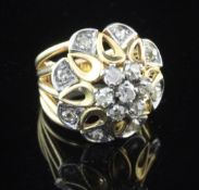 A 1960's? French 18ct gold and diamond set dress ring, of raised pierced flower head design, size