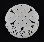 A Chinese celadon-white jade disc, carved and pierced with an endless knot and leaf scrolls, 5.7cm.