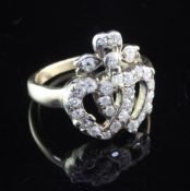 A late Victorian gold and diamond set entwined twin hearts ring, set with old cut stones, size L.