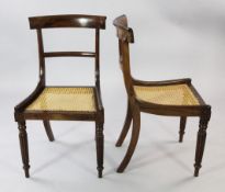 A set of six early 19th century rosewood dining chairs, with shaped crest rails and caned seats,