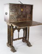 An 18th century and later Spanish walnut and iron mounted vargueno on stand, with fall front