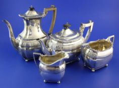 A late Victorian silver four piece tea set by Edward Barnard & Sons Ltd, with reeded band and