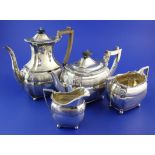 A late Victorian silver four piece tea set by Edward Barnard & Sons Ltd, with reeded band and