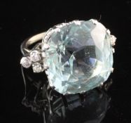 An 18ct white gold, aquamarine and diamond ring, the large fancy cut aquamarine in a raised claw