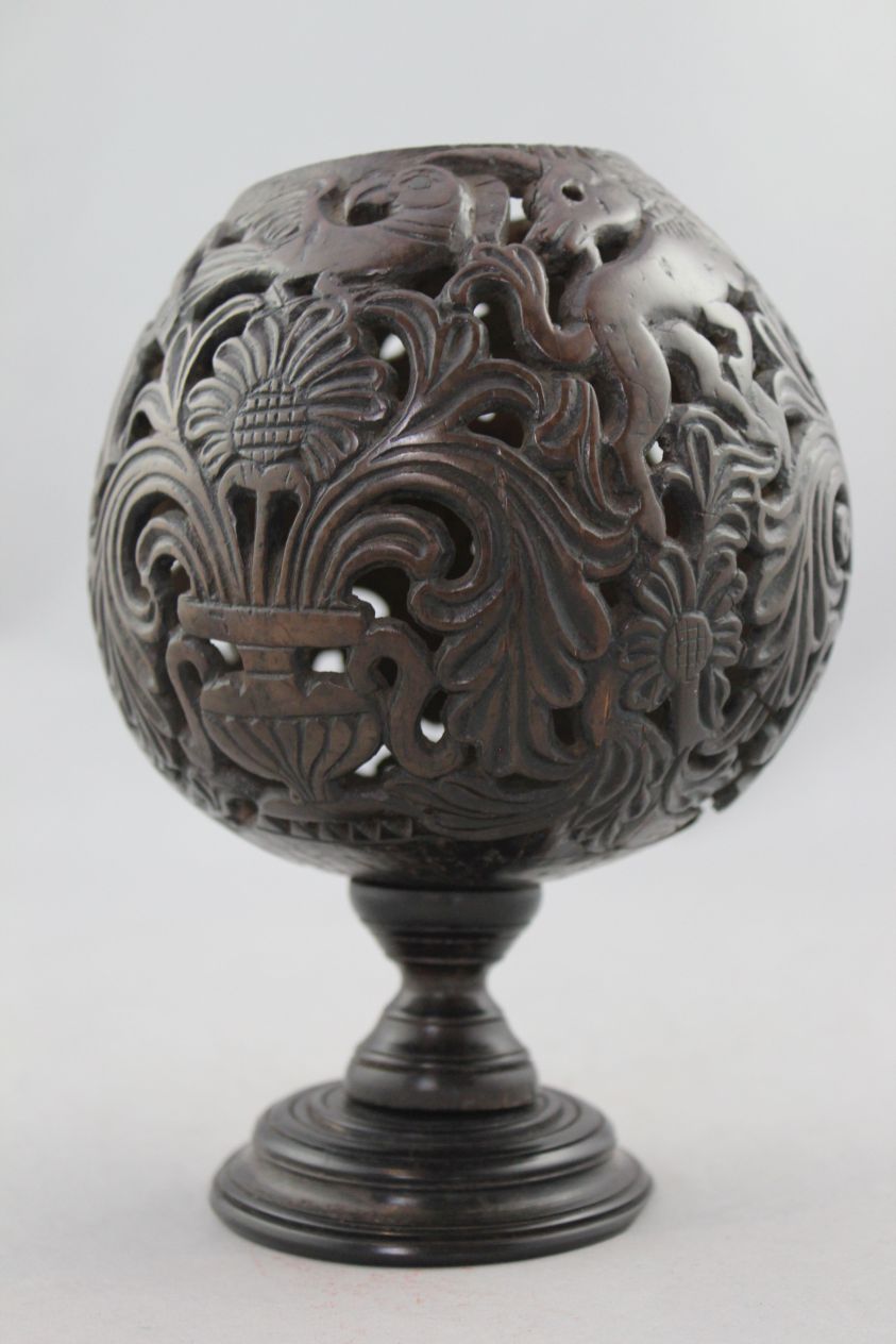 A 19th century carved and pierced coconut cup or goblet, decorated with owls, birds and vases of - Image 3 of 5