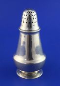 An Edwardian silver sugar caster by Liberty & Co, of tapering cylindrical form, with domed lid,