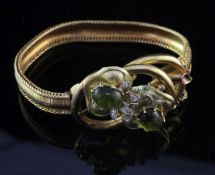 A mid 20th century continental gold, cabochon green tourmaline? and diamond bracelet, with snake