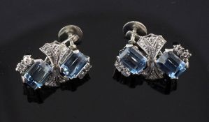 A pair of white gold, aquamarine and diamond ear clips, each clip set with two emerald cut