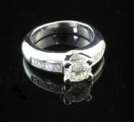 An 18ct white gold single stone diamond ring, with diamond set shoulders, the central stone weighing