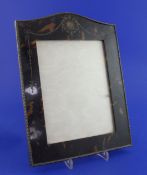 A George V tortoiseshell and silver pique mounted rectangular photograph frame, with domed top,